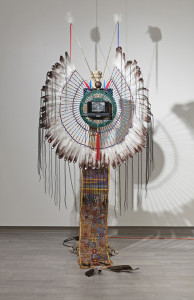 Feathered bustle with small video screen in the middle and a long beaded train
